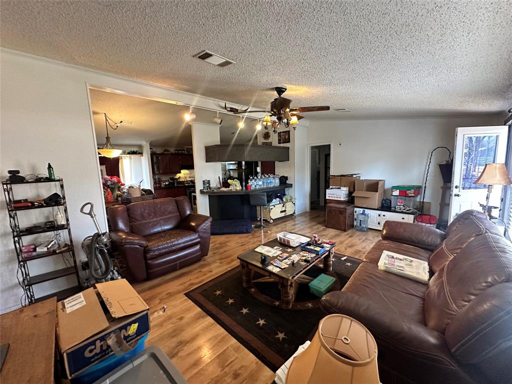 13925 Briar Road Azle, TX 76020 - Photo 6 of 22 a living room with furniture and a chandelier