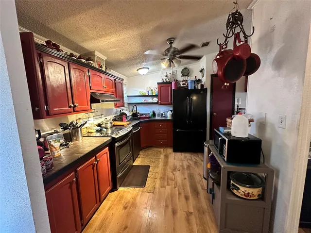 a kitchen with a sink appliances and cabinets