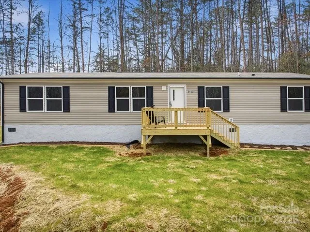 a view of a house with pool and a yard
