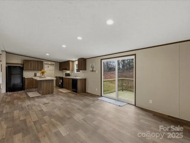 a large white kitchen with a large window