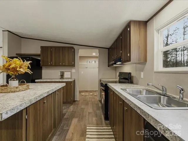 a kitchen with a sink stove top oven and refrigerator