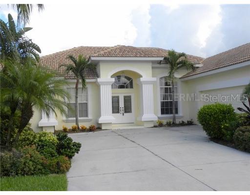 565 Marsh Creek Road Venice, FL 34292 - Photo 1 of 1 Exterior Front - Custom glass doors, professional landscaping, oversized two car garage