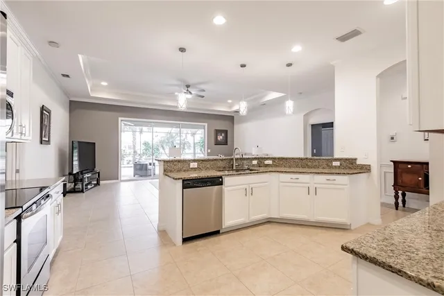 a large kitchen with kitchen island a sink appliances and cabinets