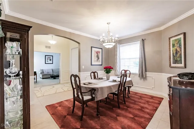 a view of a a dining room with furniture window and wooden floor