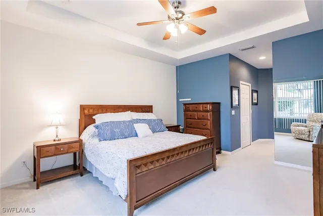 a bedroom with a bed lamp and a fireplace
