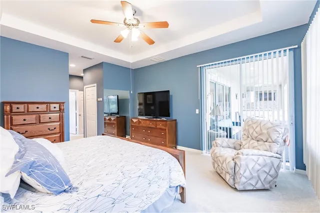 a bedroom with a large bed and a television