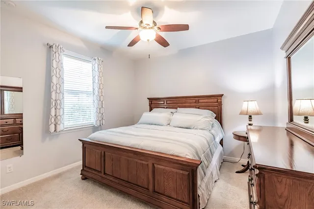 a bedroom with a bed dresser and a window