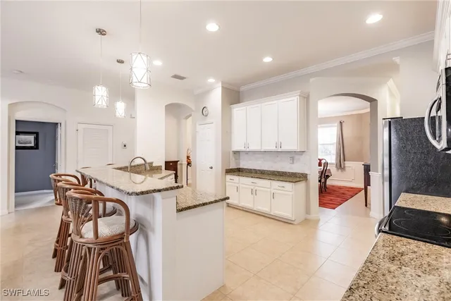 a large kitchen with a table and chairs in it