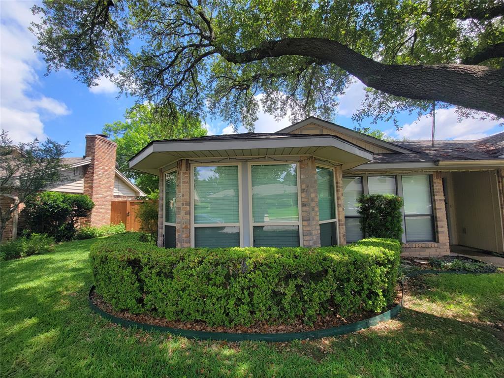 630 Country View Lane Garland, TX 75043 - Photo 2 of 29 Exterior facade featuring a bay window, brick veneer, and a manicured hedge