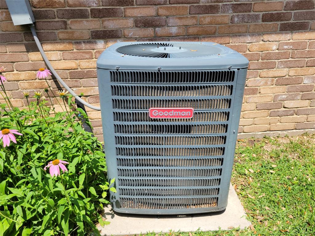 630 Country View Lane Garland, TX 75043 - Photo 22 of 29 Exterior Goodman HVAC unit on a concrete pad, set against a brick wall