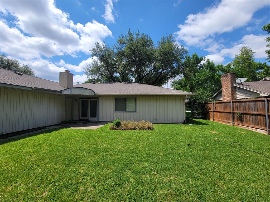 630 Country View Lane Garland, TX 75043 - Photo 29 of 29 Expansive backyard featuring a manicured lawn, a concrete patio, and a privacy fence