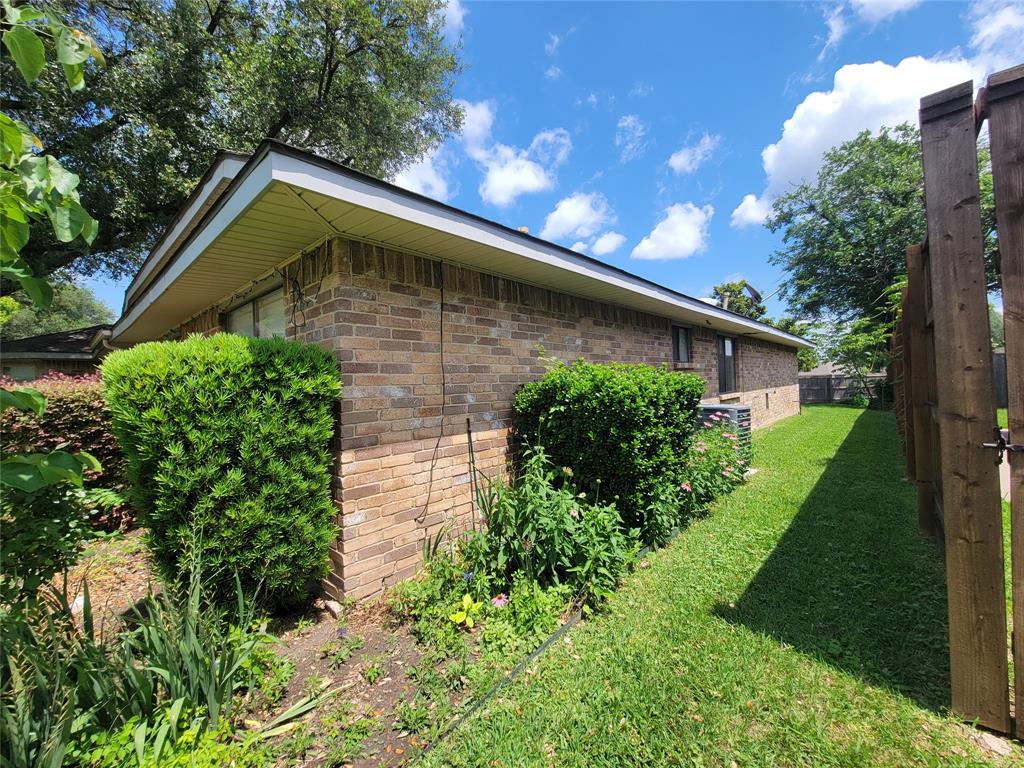 630 Country View Lane Garland, TX 75043 - Photo 5 of 29 Brick exterior featuring a dark composition shingle roof and white soffits