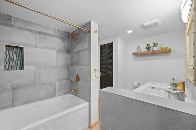 a bathroom with a tub and shower
