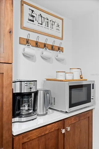 a kitchen with stainless steel appliances granite countertop a sink and a microwave
