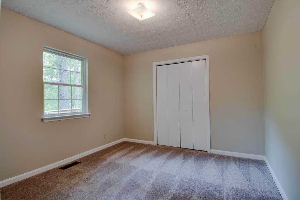 121 Brookside Point Springfield, TN 37172 - Photo 13 of 19 an empty room with wooden floor and windows