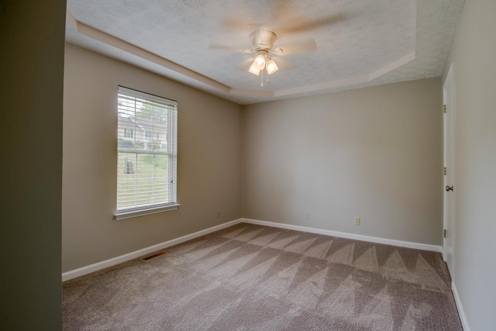 121 Brookside Point Springfield, TN 37172 - Photo 9 of 19 an empty room with a chandelier fan and windows