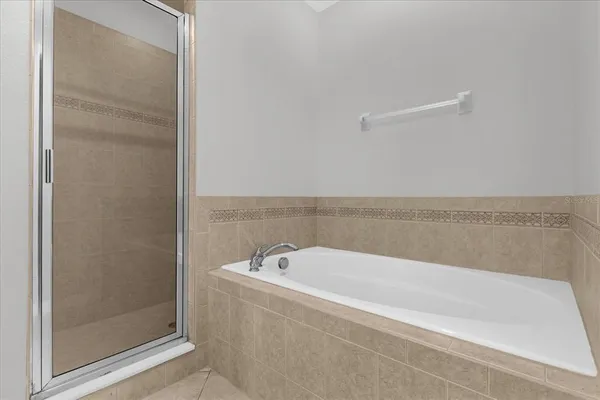 a spacious bathroom with shower and bathtub