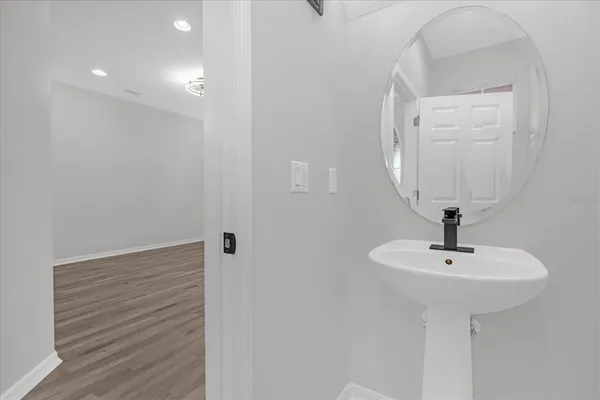 a bathroom with a sink a mirror and shower