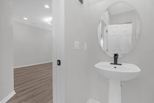 a bathroom with a sink a mirror and shower