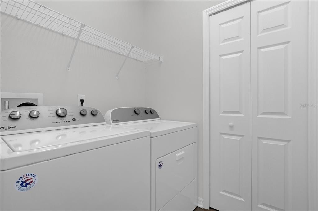 9450 Silver Buttonwood Street Orlando, FL 32832 - Photo 22 of 25 a utility room with dryer and washer