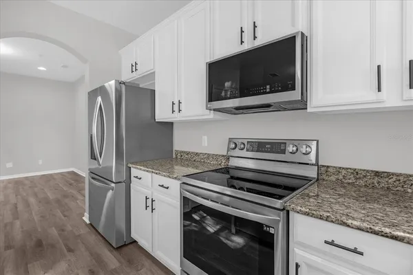 a kitchen with a stove microwave and refrigerator