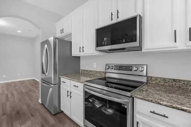 a kitchen with a stove microwave and refrigerator