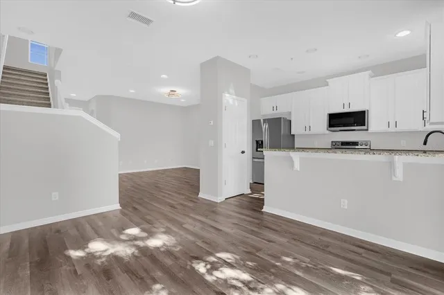 a view of a kitchen with microwave and cabinets