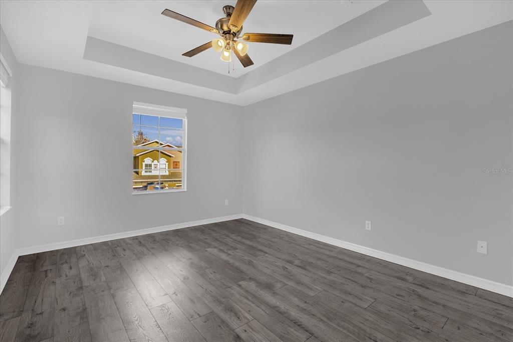 9450 Silver Buttonwood Street Orlando, FL 32832 - Photo 10 of 25 an empty room with a window and ceiling fan