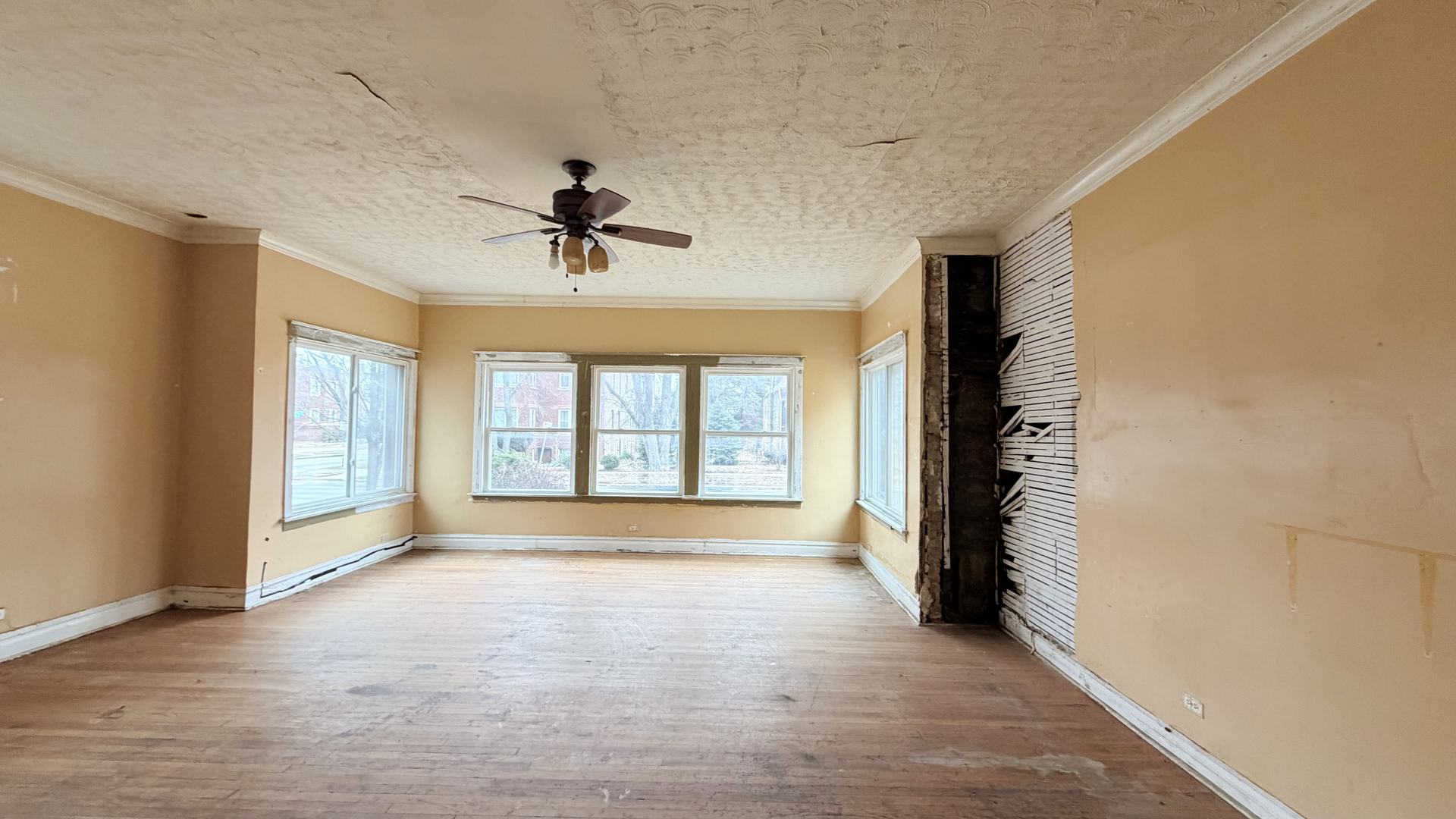 7704 South Ada Street Chicago, IL 60620 - Photo 2 of 10 a view of an empty room with a window and a kitchen