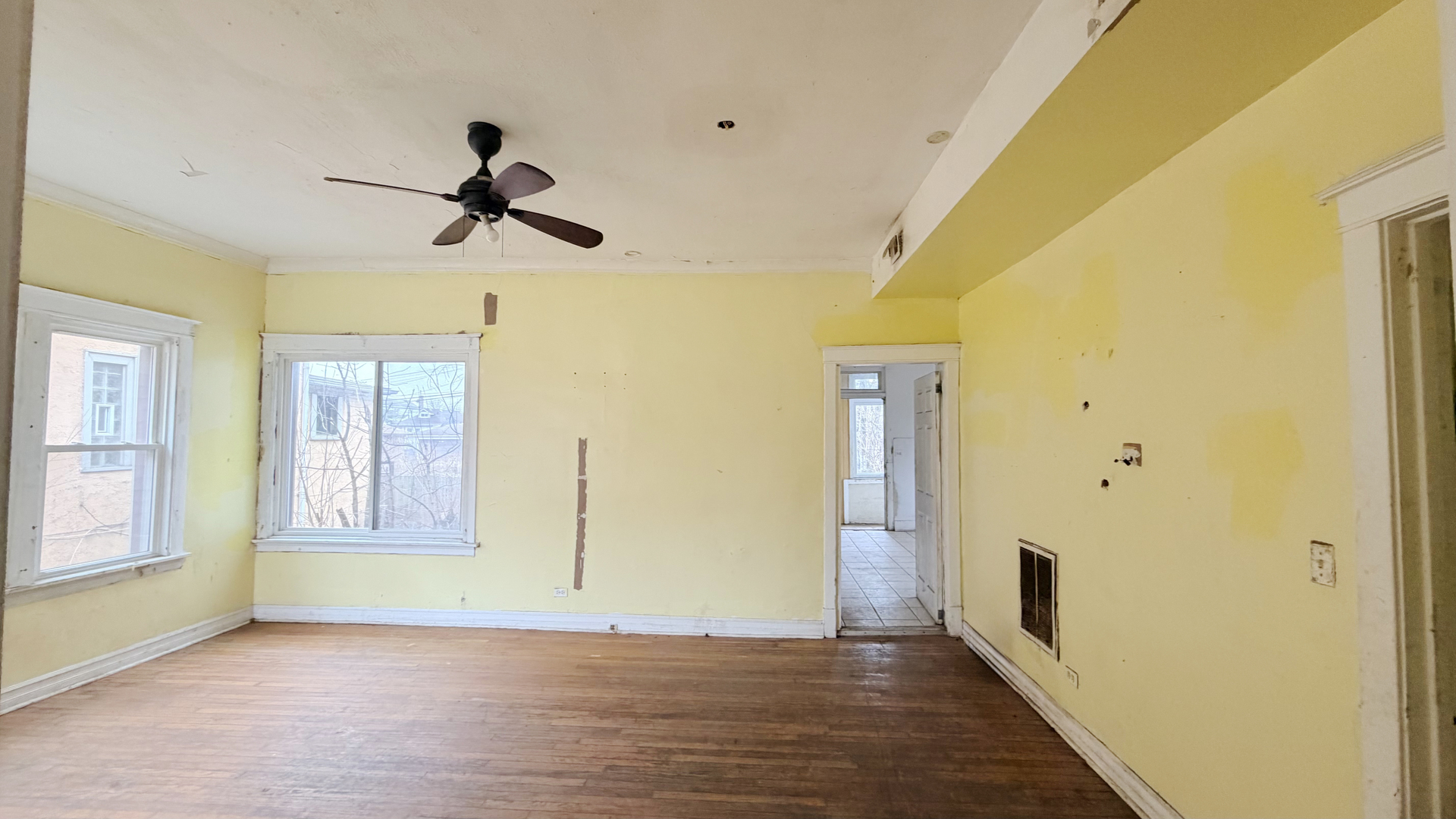7704 South Ada Street Chicago, IL 60620 - Photo 3 of 10 a view of empty room with wooden floor and fan