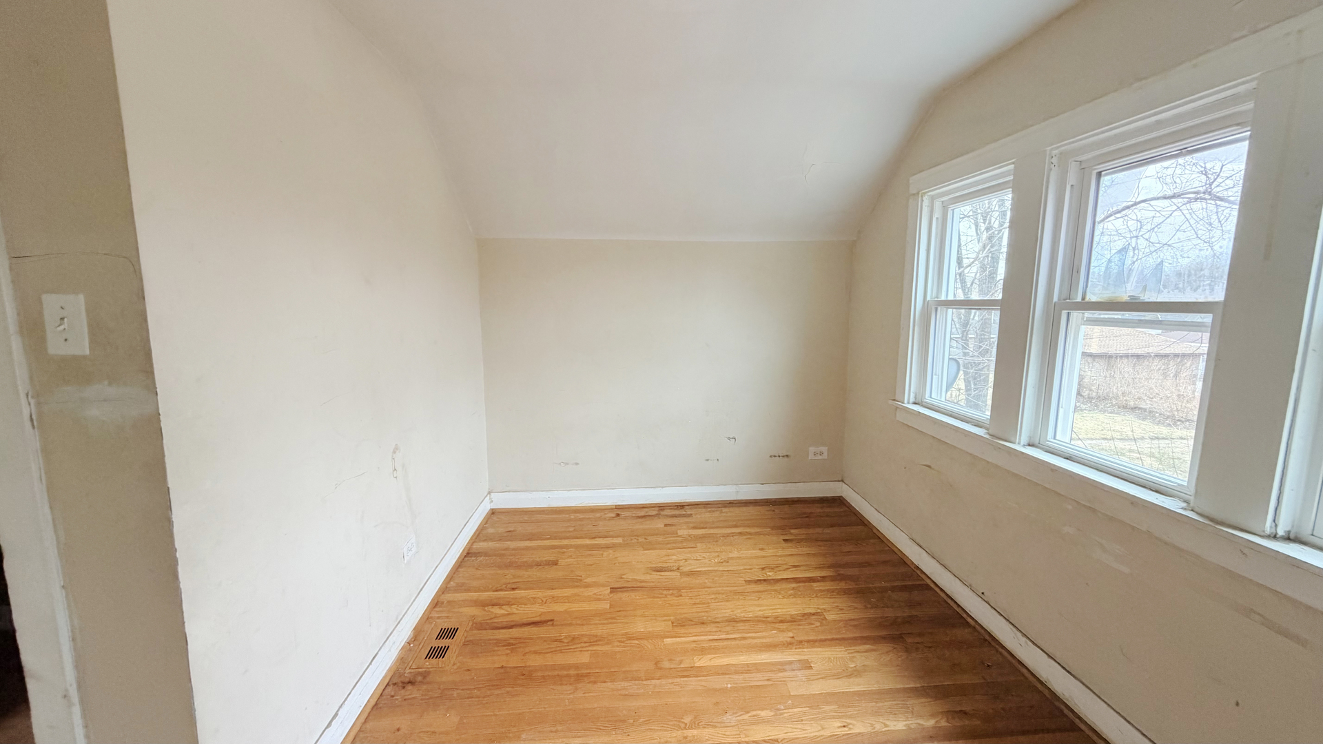 7704 South Ada Street Chicago, IL 60620 - Photo 5 of 10 a view of a hallway with wooden floor and a window
