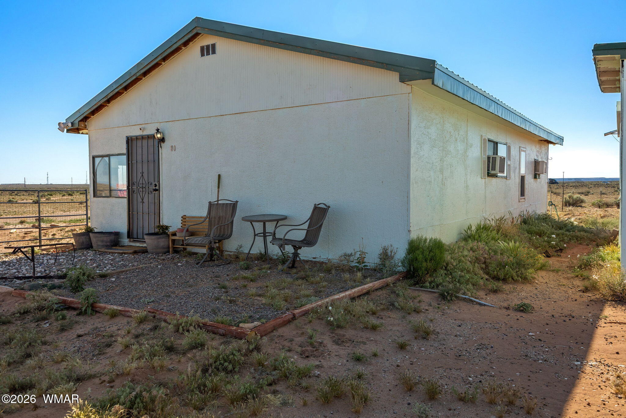 80 L K Ranch Road Holbrook, AZ 86025 - Photo 13 of 29 a backyard of a house with table and chairs