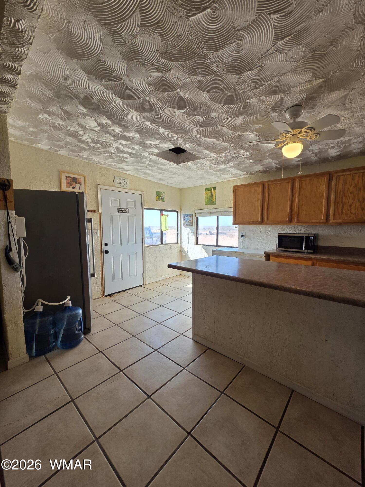 80 L K Ranch Road Holbrook, AZ 86025 - Photo 15 of 29 a kitchen with stainless steel appliances granite countertop a refrigerator and a stove