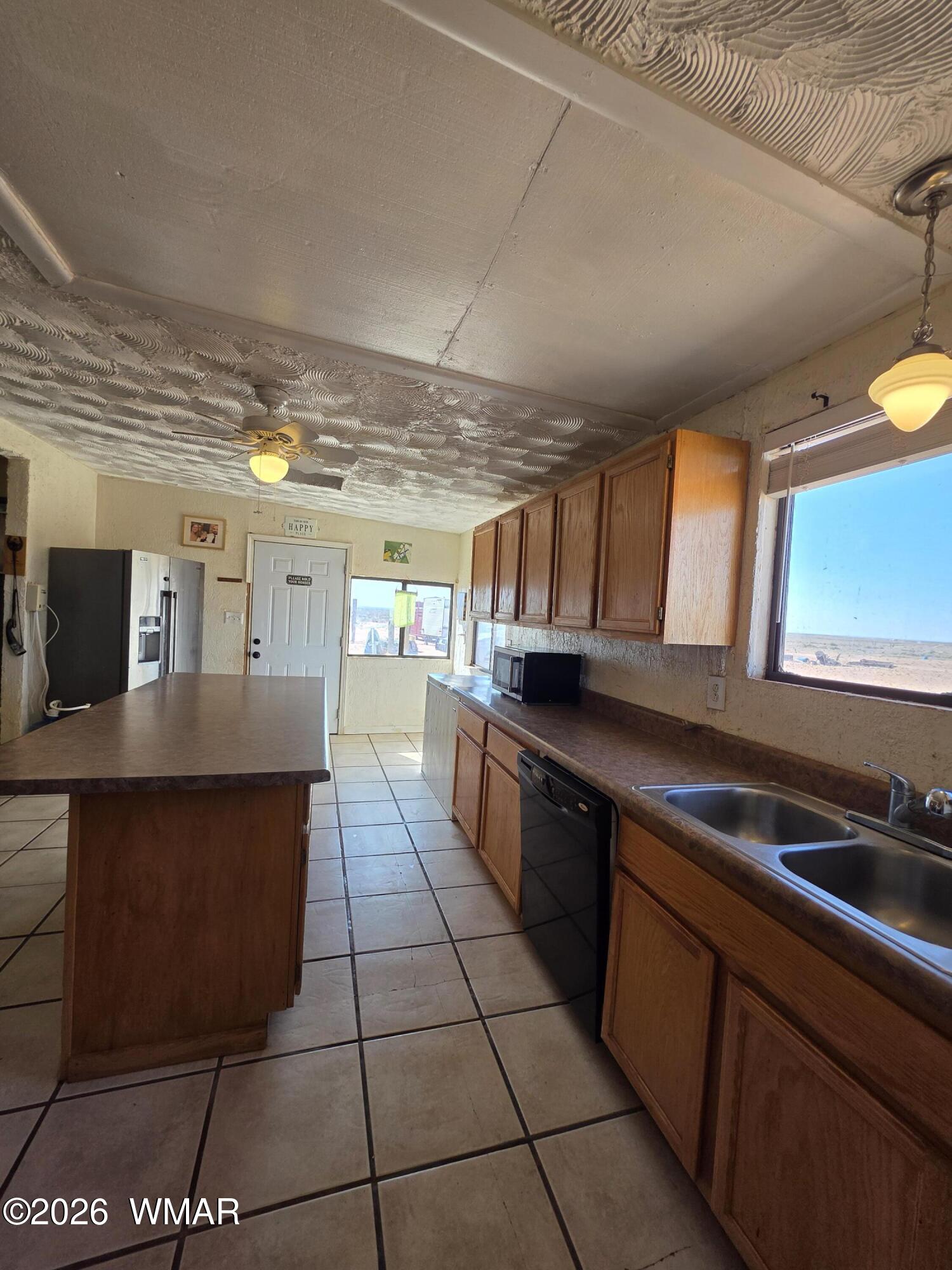 80 L K Ranch Road Holbrook, AZ 86025 - Photo 17 of 29 a large kitchen with stainless steel appliances a counter space and a view of living room