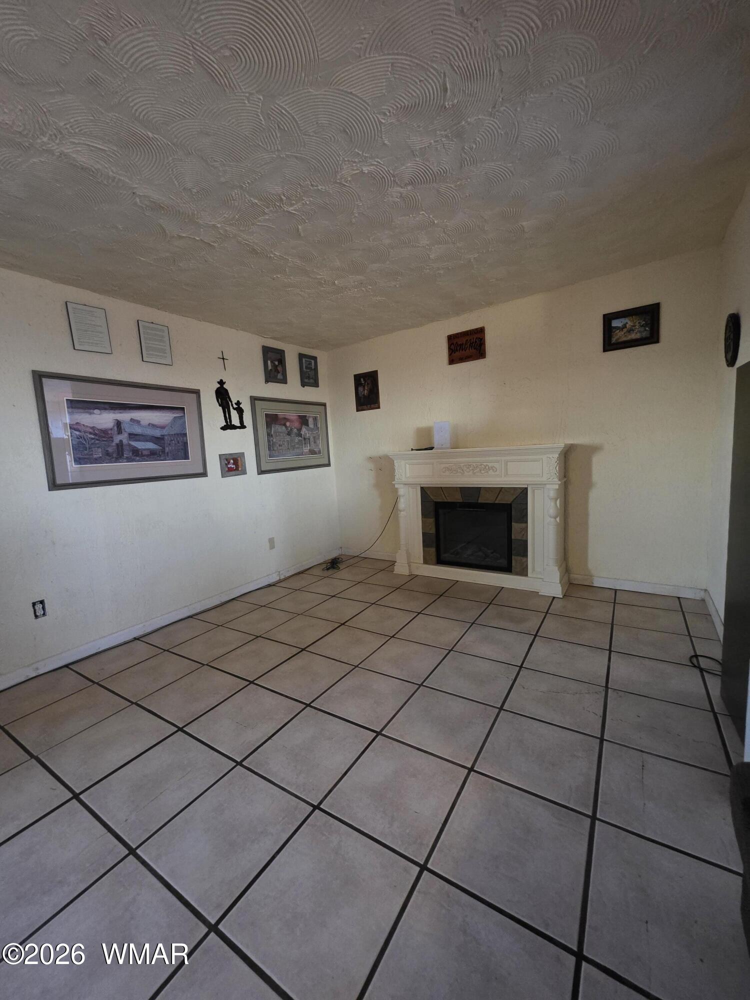 80 L K Ranch Road Holbrook, AZ 86025 - Photo 18 of 29 a bedroom with a bed and a fireplace