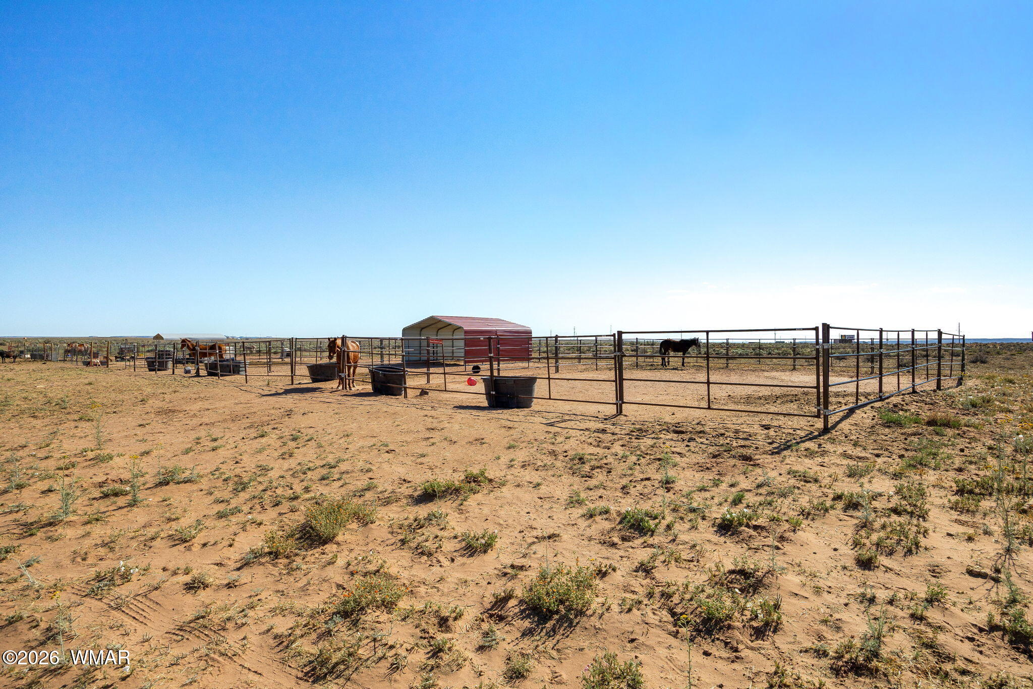 80 L K Ranch Road Holbrook, AZ 86025 - Photo 4 of 29 a view of a dry yard with a barn