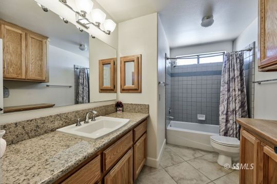 1260 Arroyo Street Ridgecrest, CA 93555 - Photo 18 of 44 a bathroom with a granite countertop sink a toilet and shower