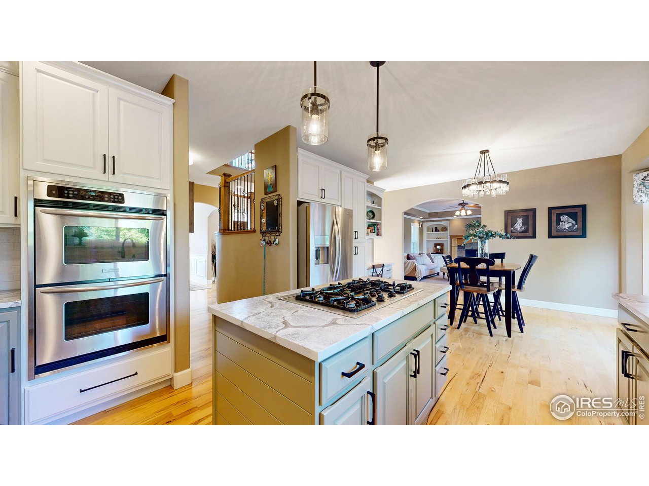 8398 Spinnaker Bay Drive Windsor, CO 80528 - Photo 11 of 40 a kitchen with a stove a refrigerator and a dining table