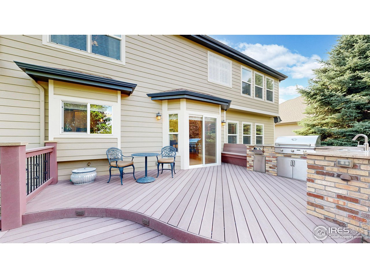 8398 Spinnaker Bay Drive Windsor, CO 80528 - Photo 12 of 40 a view of a house with a barbeque and wooden bench