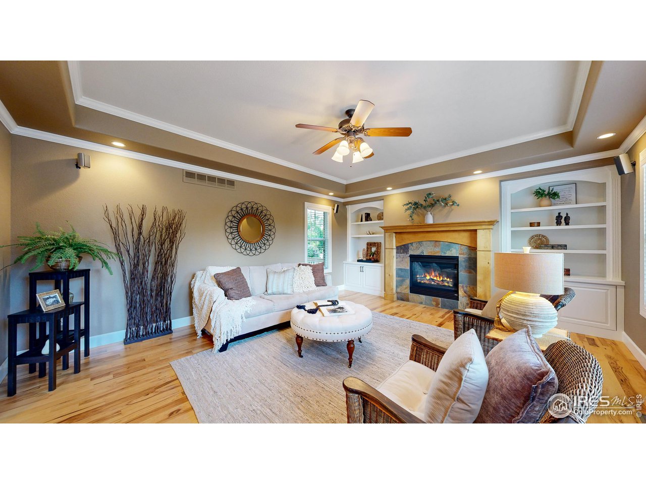 8398 Spinnaker Bay Drive Windsor, CO 80528 - Photo 13 of 40 a living room with furniture a fireplace and a potted plant