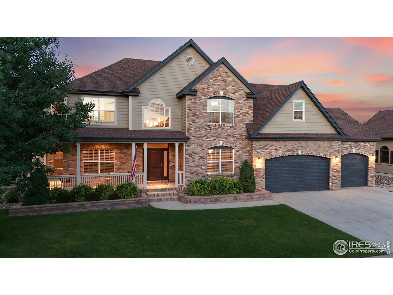 8398 Spinnaker Bay Drive Windsor, CO 80528 - Photo 2 of 40 a front view of a house with a garden