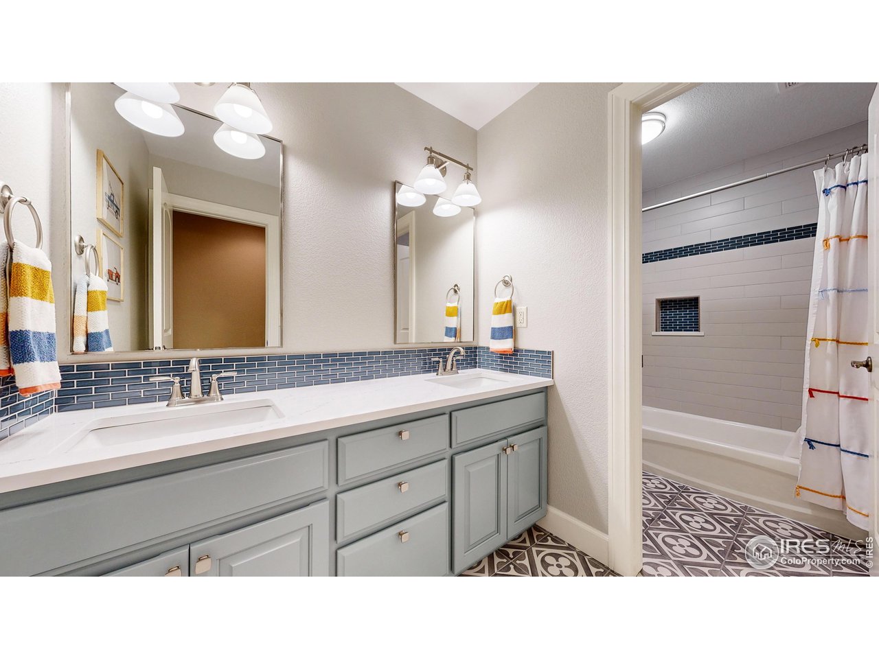 8398 Spinnaker Bay Drive Windsor, CO 80528 - Photo 21 of 40 a bathroom with a sink a mirror and a shower