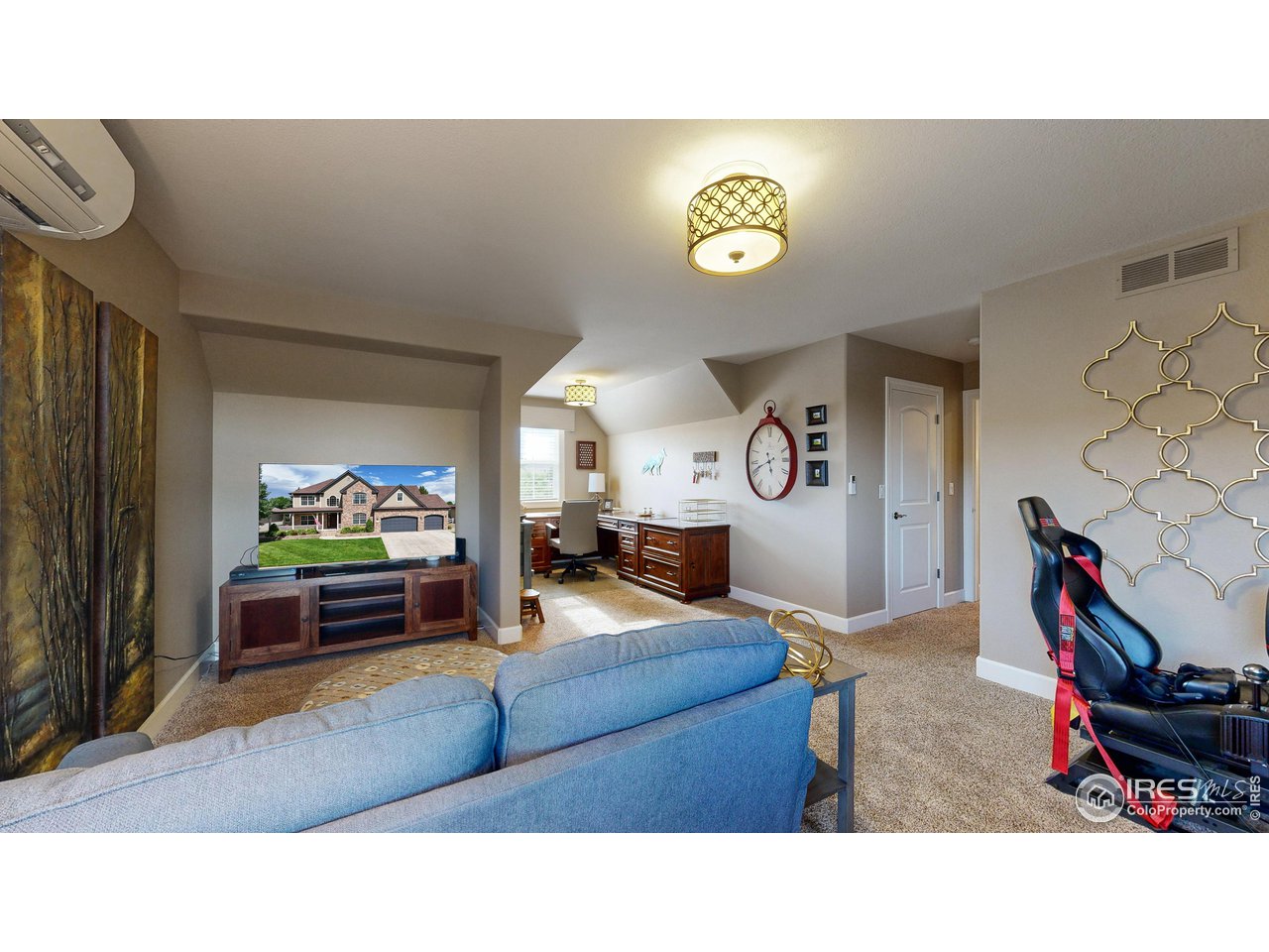 8398 Spinnaker Bay Drive Windsor, CO 80528 - Photo 22 of 40 a living room with furniture and a flat screen tv