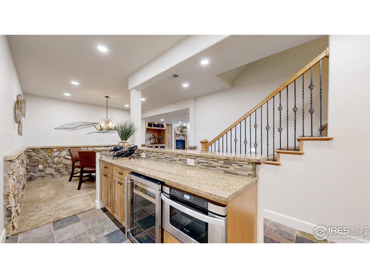 8398 Spinnaker Bay Drive Windsor, CO 80528 - Photo 24 of 40 a open kitchen with stainless steel appliances kitchen island a chandelier