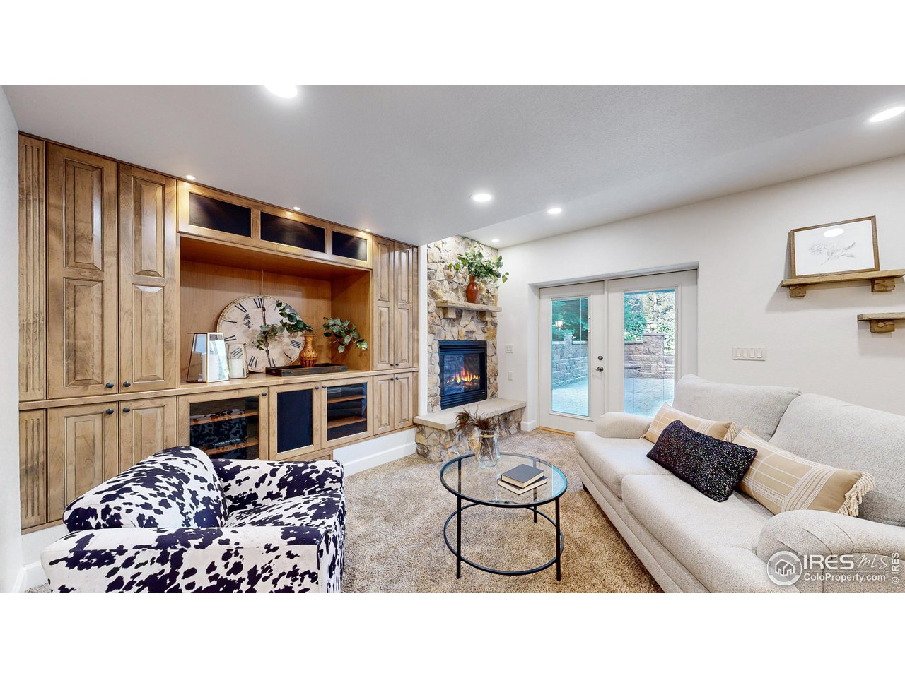 8398 Spinnaker Bay Drive Windsor, CO 80528 - Photo 25 of 40 a living room with furniture a flat screen tv and a fireplace
