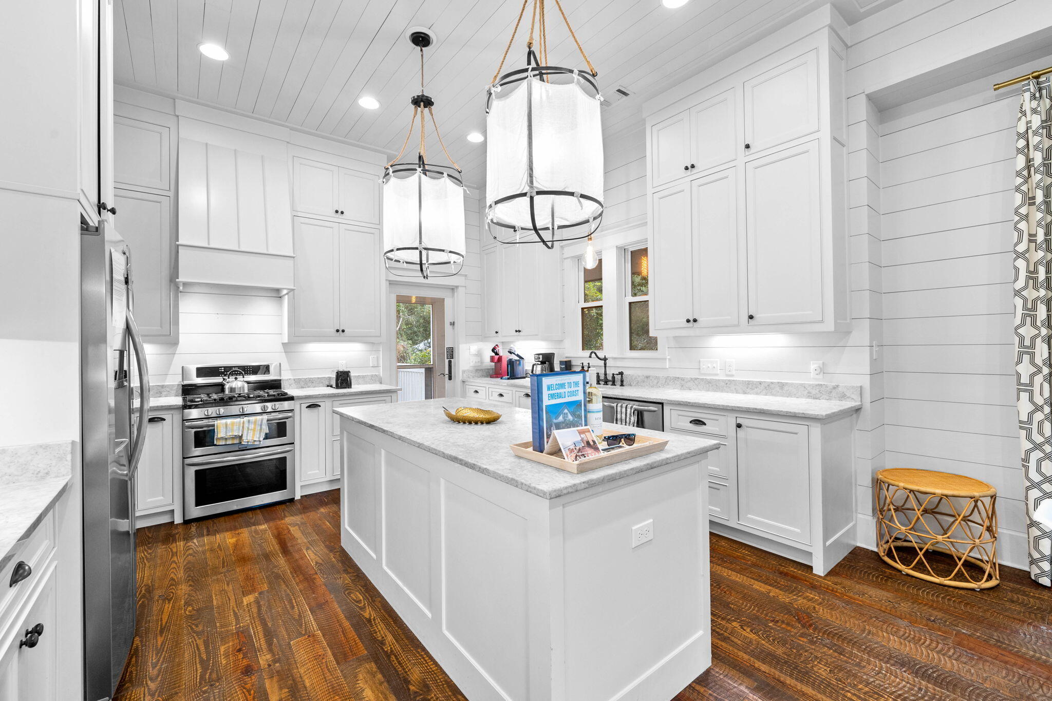 213 Bramble Street Santa Rosa Beach, FL 32459 - Photo 23 of 62 a kitchen with white cabinets stove and refrigerator