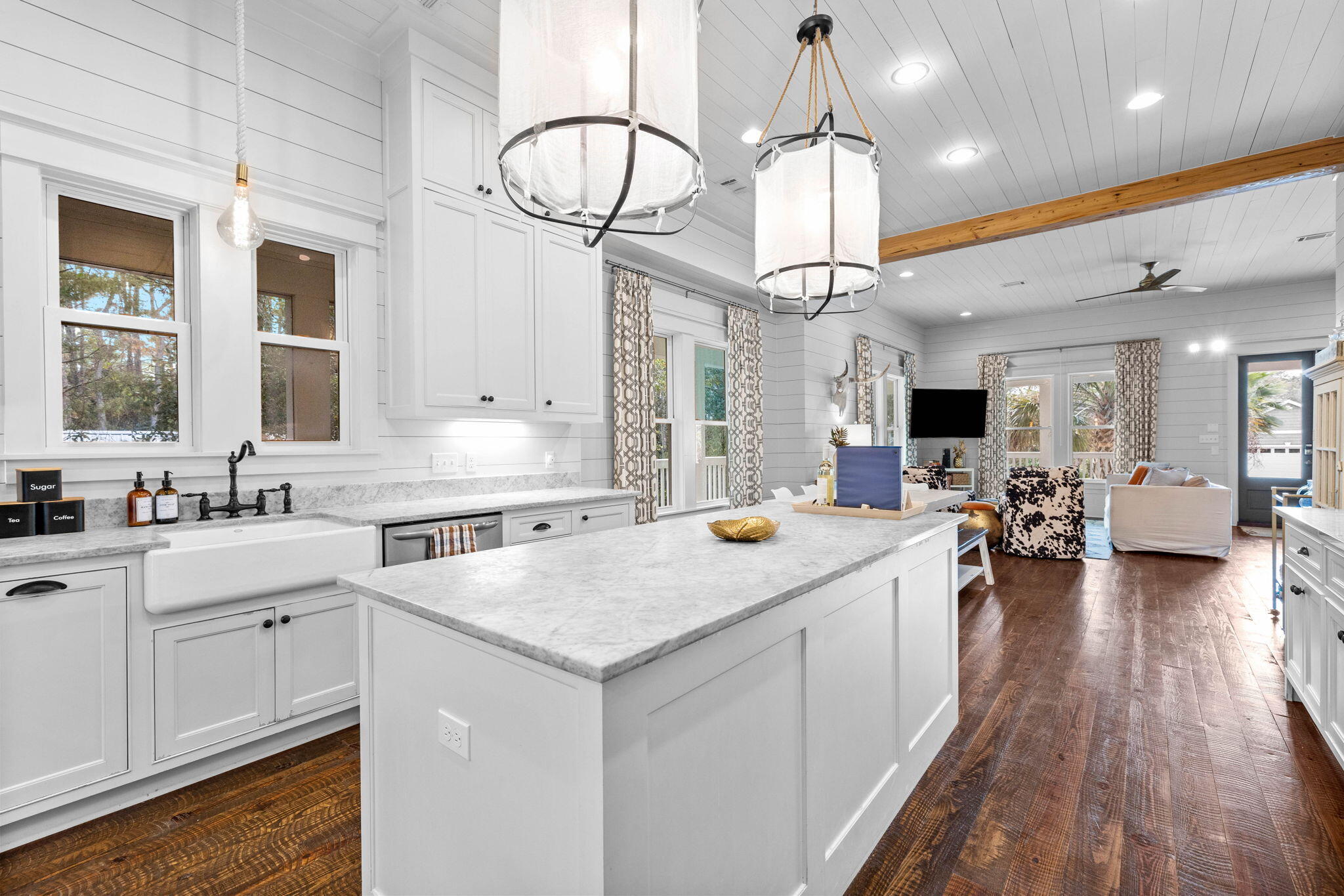 213 Bramble Street Santa Rosa Beach, FL 32459 - Photo 26 of 62 a kitchen with a sink dishwasher a stove and a dining table with wooden floor