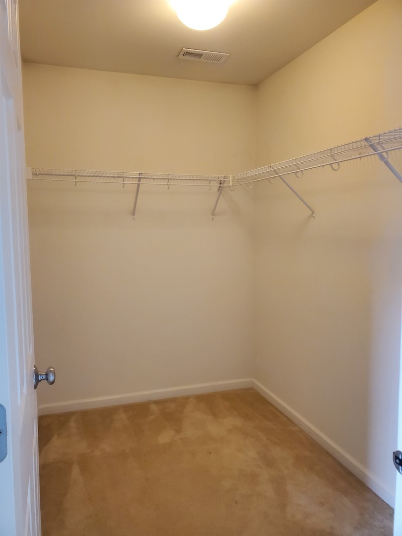 10070 Cummings Street, Unit 3401 Huntley, IL 60142 - Photo 20 of 27 a view of a room with racks on the wall