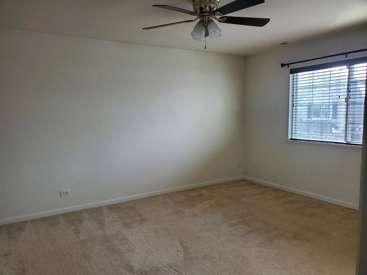 10070 Cummings Street, Unit 3401 Huntley, IL 60142 - Photo 21 of 27 an empty room with a window and a fan
