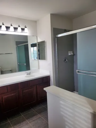 an empty room with a ceiling fan and carpet